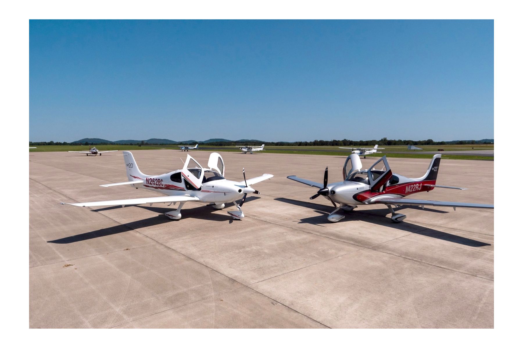 The TopFlight Cirrus fleet parked on the ramp in front of the hangars at John C. Tune Airport